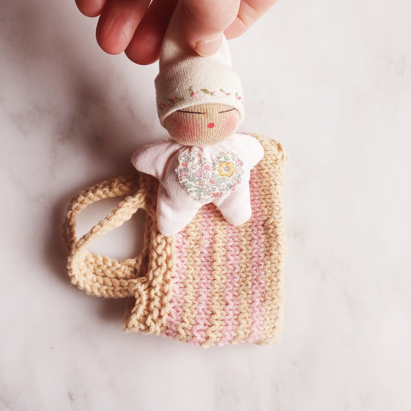 Tiny sleepy baby and knitted bag set